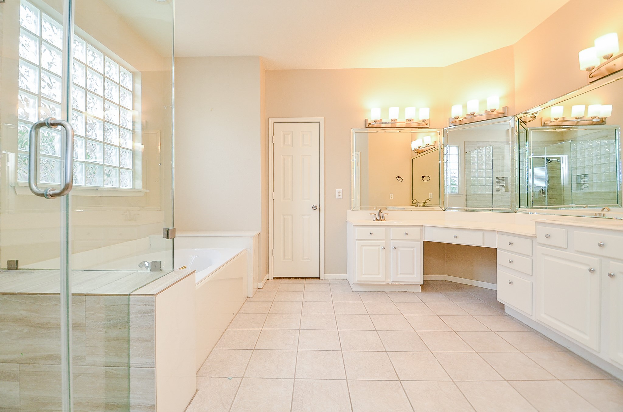 1222 Ragsdale Lane Katy, TX 77494 - Photo 18 of 31 Calming primary bath with excellent lighting, double sinks, a separate shower and jetted tub. Spacious vanity provides knee space for a seat. Good storage, updated frameless shower with updated tile.