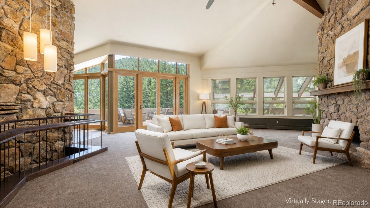 1323 South Snyder Gulch Road Evergreen, CO 80439 - Photo 3 of 47 a living room with furniture and a floor to ceiling window