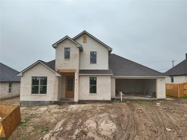 a view of a house with a yard and garage