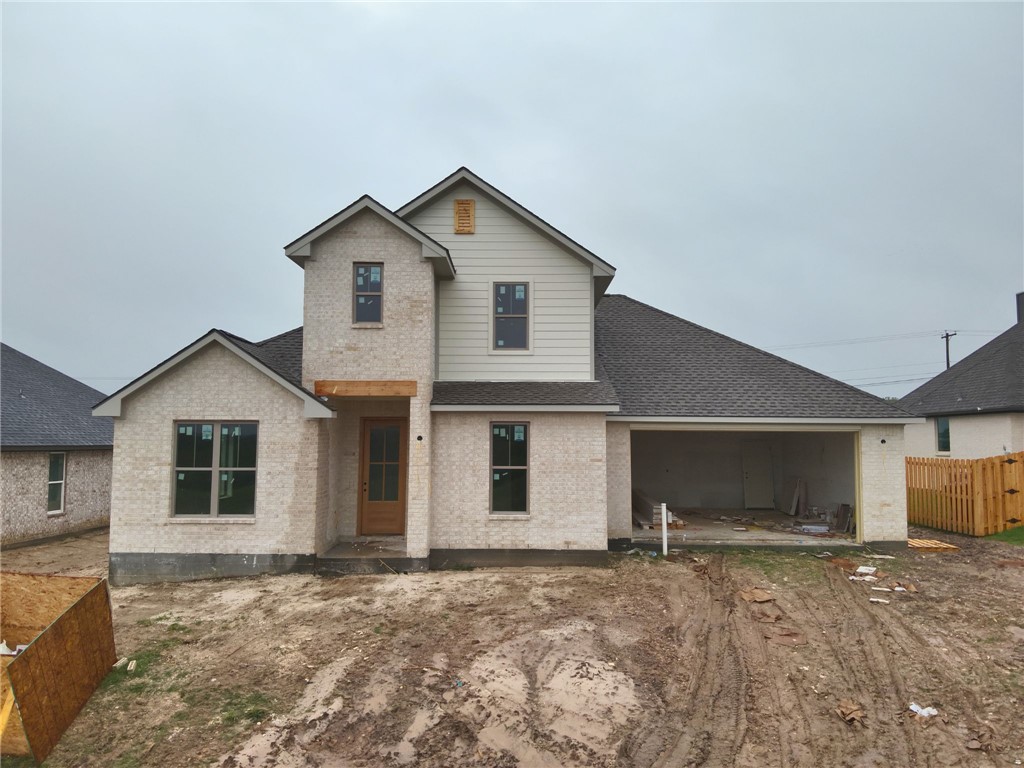 a view of a house with a yard and garage