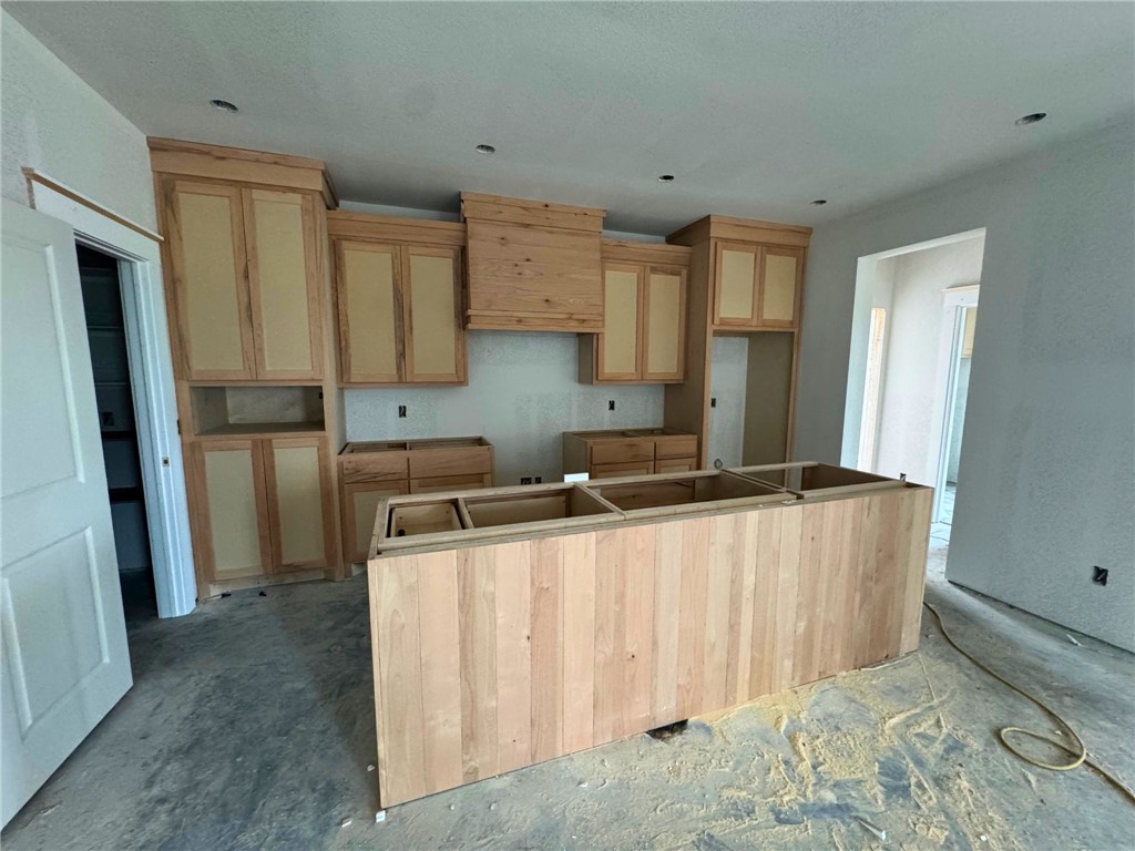 162 Buffalo Rdg Road Giddings, TX 78942 - Photo 5 of 13 a kitchen with stainless steel appliances a refrigerator a sink a stove a microwave and island