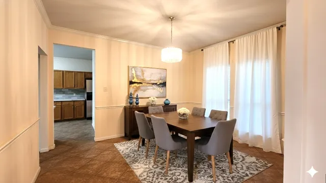 a view of a dining room with furniture and a window