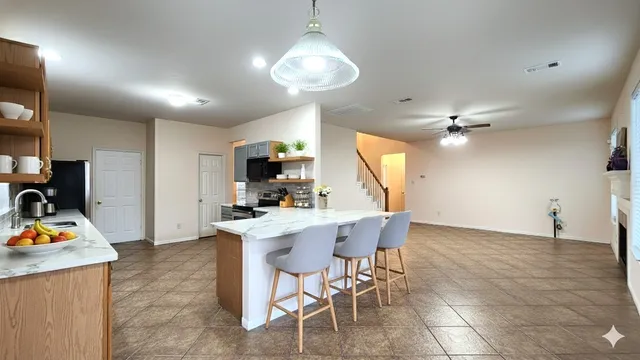 a view of a dining room with furniture and a chandelier