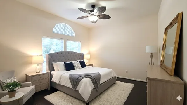 a bedroom with a bed and a chandelier