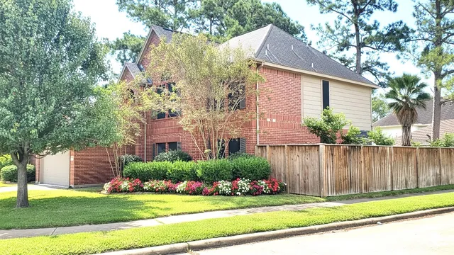 a view of a house with a yard and plants