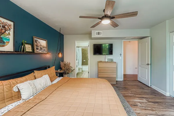 a bedroom with a bed and a flat screen tv