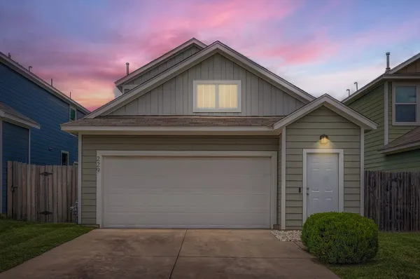 a front view of a house with garage