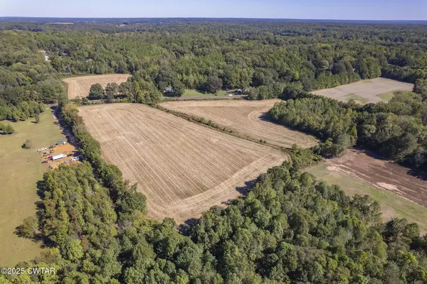 an aerial view of a house with a yard