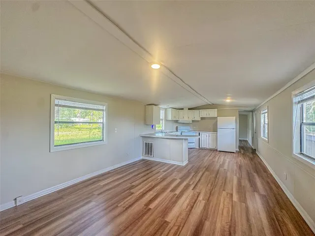 a view of kitchen and wooden floor