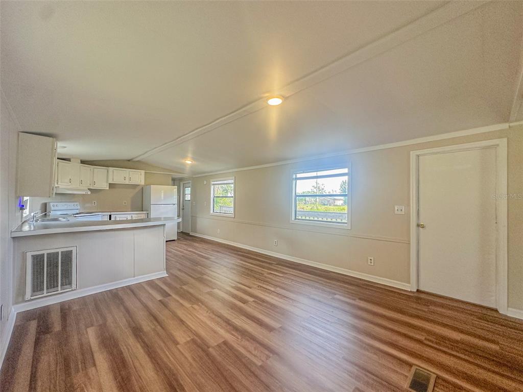 2218 Ellie Road, Unit 1 Auburndale, FL 33823 - Photo 10 of 21 an empty room with wooden floor and windows