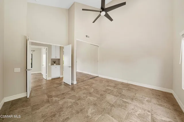 a view of a livingroom with a ceiling fan and window