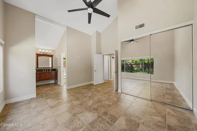 a bathroom with a granite countertop sink a mirror and a vanity