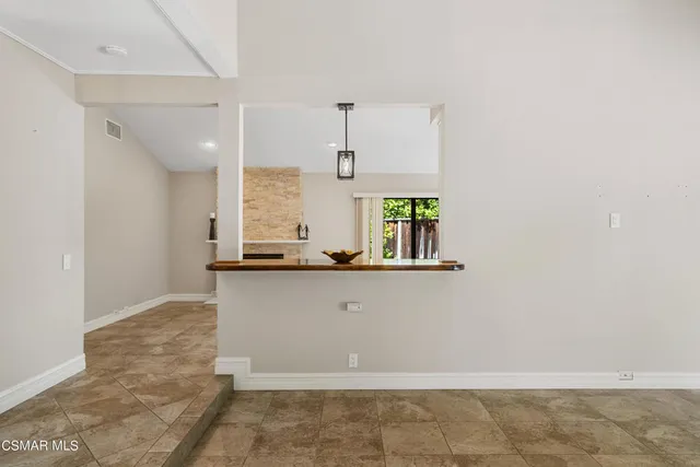 a view of a livingroom with a fireplace and window