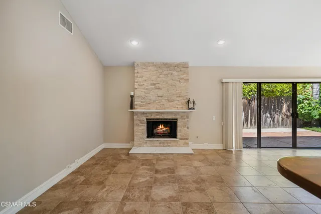 a view of a kitchen with a sink oven fire place and a refrigerator