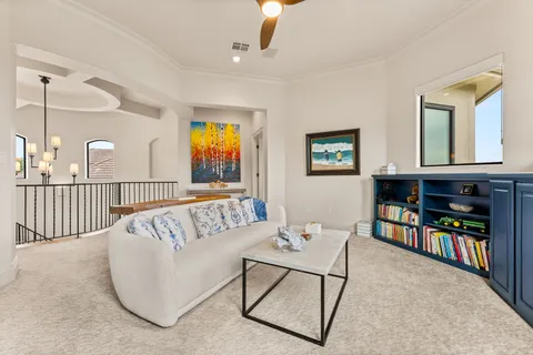 a living room with furniture and baby crib
