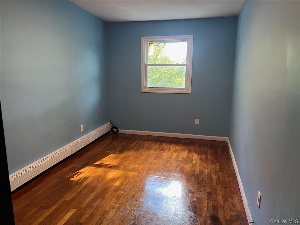 708 Silver Lake-Scotchtown Road Middletown, NY 10941 - Photo 14 of 25 Spare room featuring a baseboard radiator and hardwood / wood-style floors
