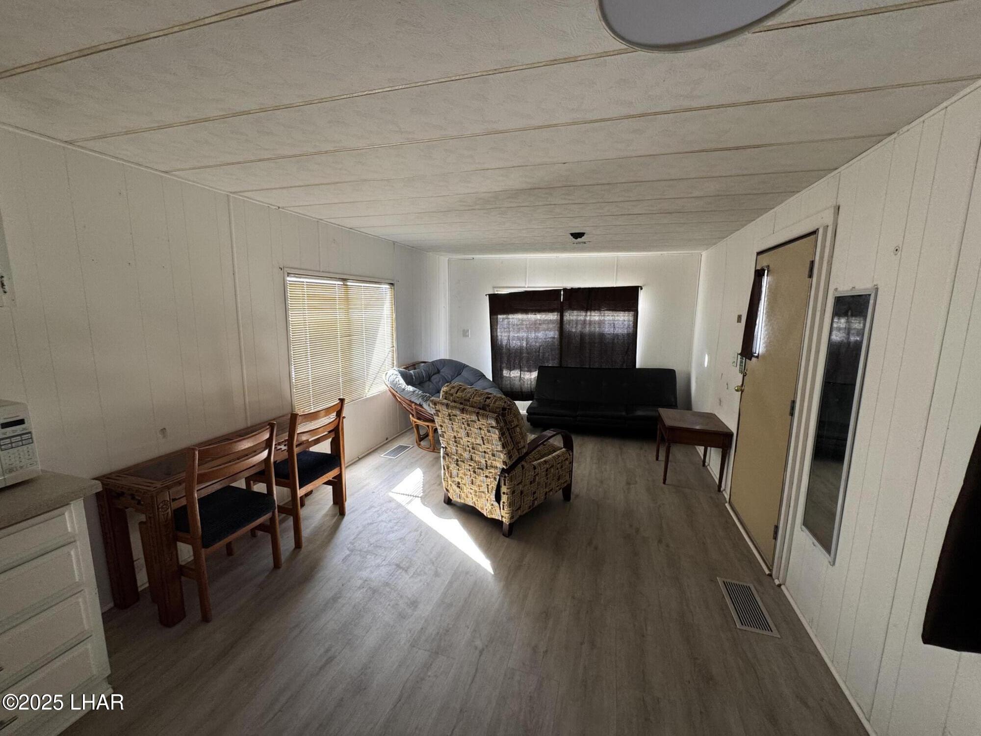 10186 Harbor View Road Parker, AZ 85344 - Photo 6 of 16 a living room with furniture and a flat screen tv