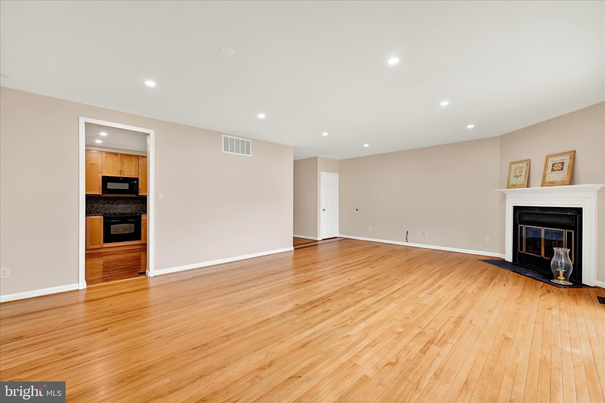 2317 Wonderview Road Lutherville-Timonium, MD 21093 - Photo 11 of 27 a view of empty room with wooden floor and fireplace