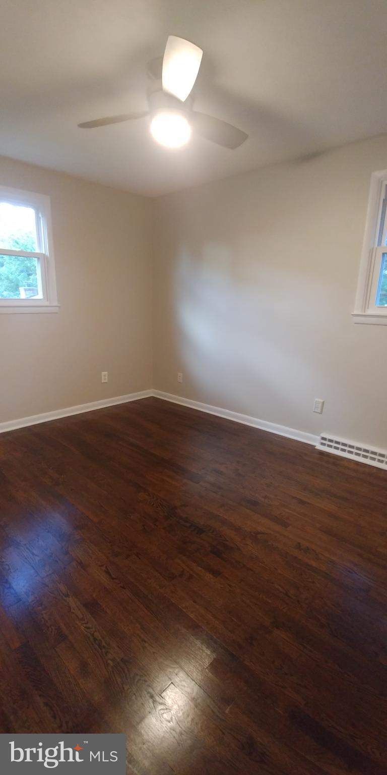 6750 Amherst Road Bryans Road, MD 20616 - Photo 12 of 15 an empty room with wooden floor and windows