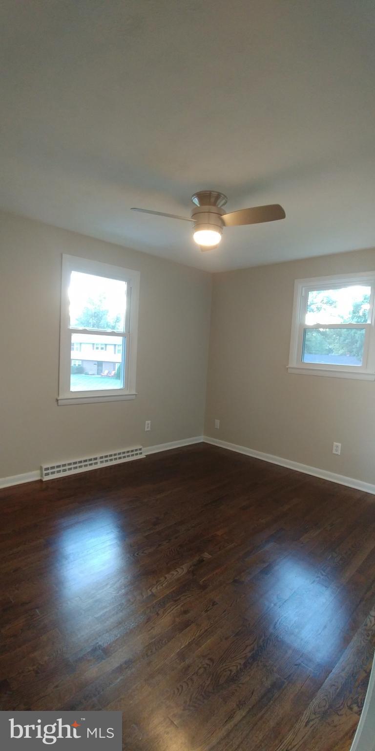 6750 Amherst Road Bryans Road, MD 20616 - Photo 14 of 15 an empty room with wooden floor and windows