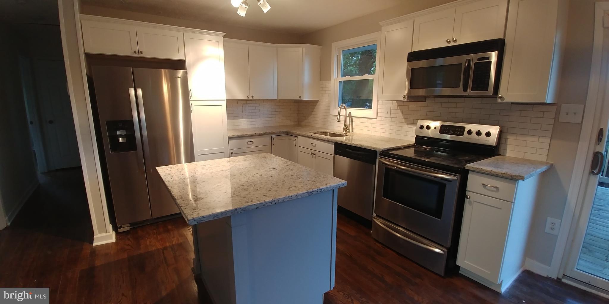 6750 Amherst Road Bryans Road, MD 20616 - Photo 5 of 15 a kitchen with granite countertop stainless steel appliances and wooden cabinets