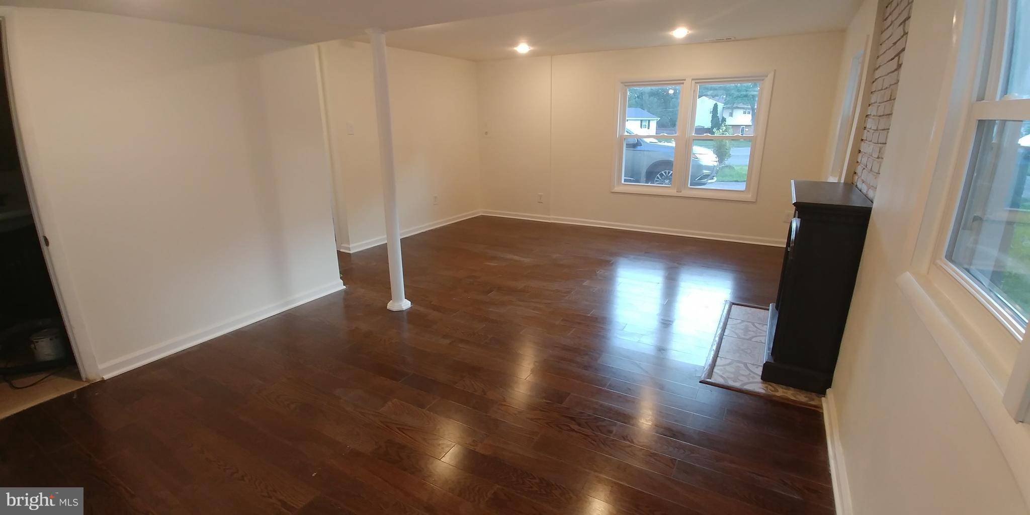 6750 Amherst Road Bryans Road, MD 20616 - Photo 8 of 15 an empty room with wooden floor and windows