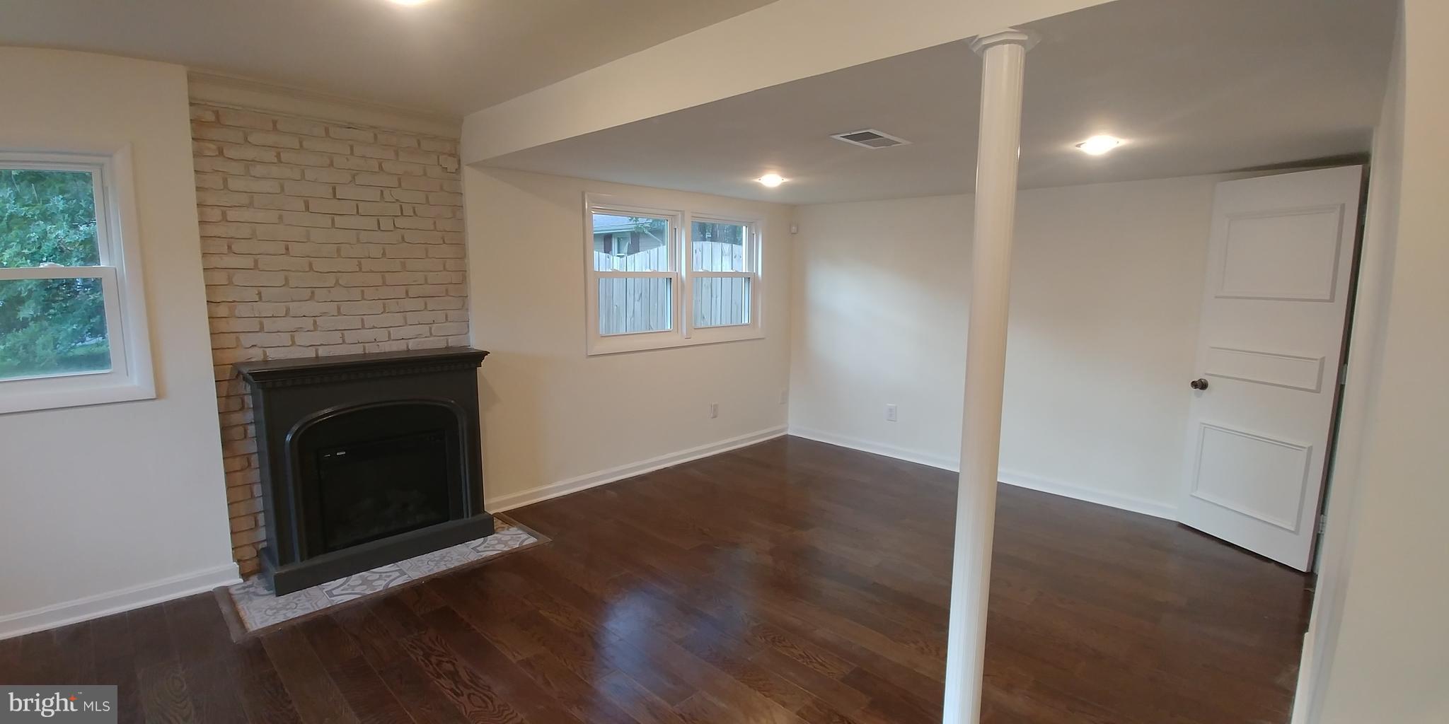 6750 Amherst Road Bryans Road, MD 20616 - Photo 9 of 15 a view of an empty room with wooden floor and a window
