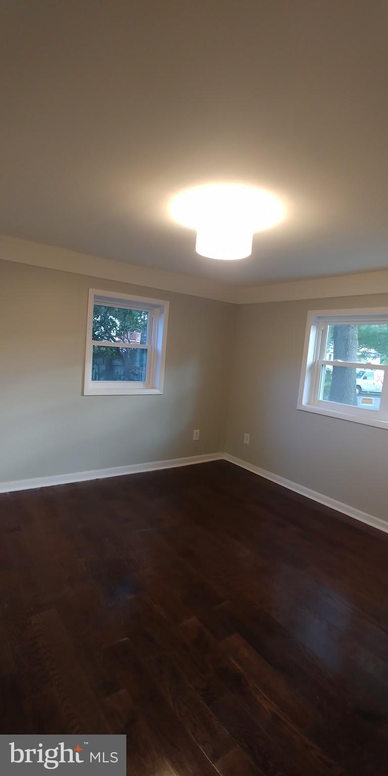 6750 Amherst Road Bryans Road, MD 20616 - Photo 10 of 15 an empty room with wooden floor and windows