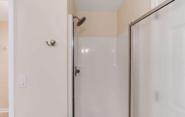 139 Clover Court Temple, GA 30179 - Photo 17 of 32 a bathroom with a glass shower door