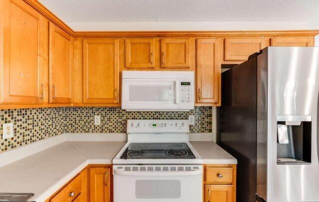 139 Clover Court Temple, GA 30179 - Photo 10 of 32 a kitchen with a stove a refrigerator and a dishwasher