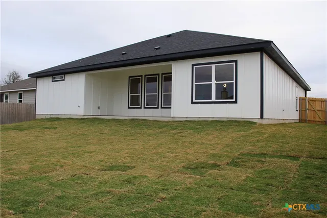 a view of wooden floor and windows in a room