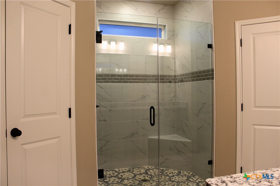 3824 Keller Road Temple, TX 76504 - Photo 16 of 22 a bathroom with a glass shower door