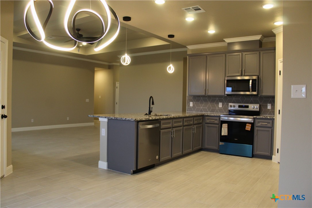 3824 Keller Road Temple, TX 76504 - Photo 6 of 22 a kitchen with a sink and a stove top oven with a dishwasher