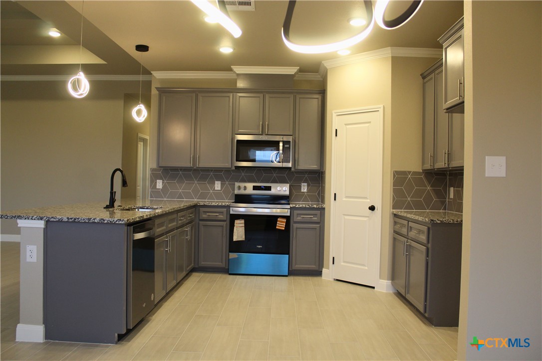 3824 Keller Road Temple, TX 76504 - Photo 7 of 22 a kitchen with stainless steel appliances granite countertop a stove a sink and a refrigerator