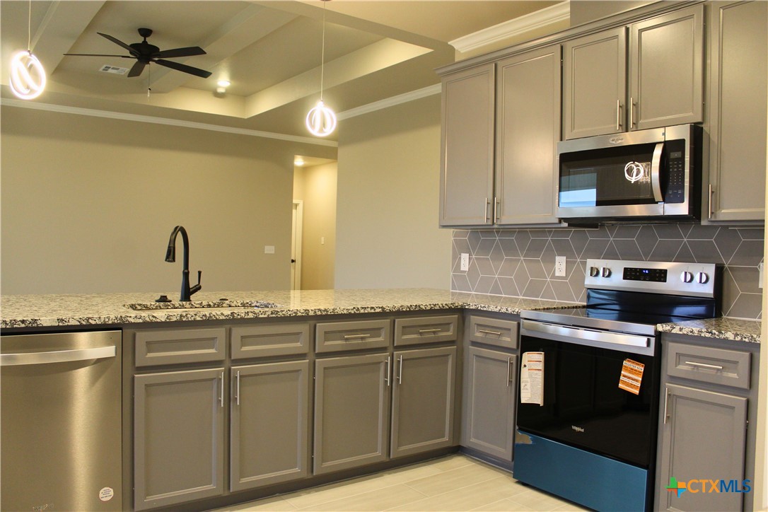 3824 Keller Road Temple, TX 76504 - Photo 8 of 22 a kitchen with stainless steel appliances granite countertop a sink and a stove