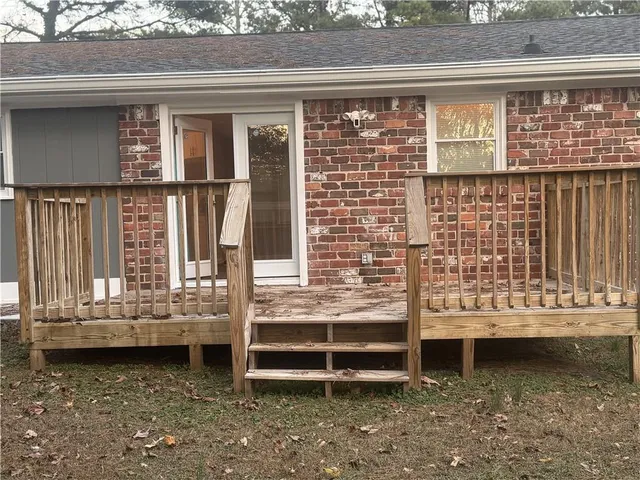 a view of a yard with wooden fence