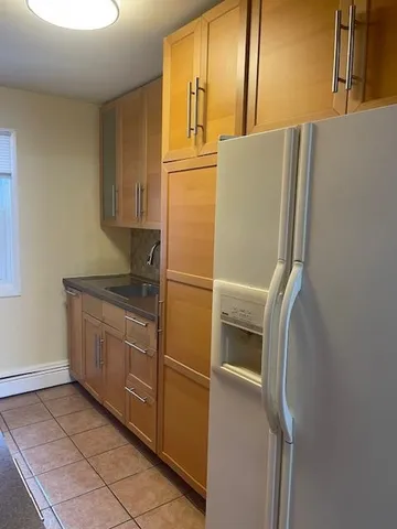 a kitchen with stainless steel appliances granite countertop a refrigerator and a stove