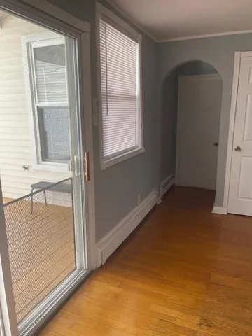 a view of a room window and wooden floor