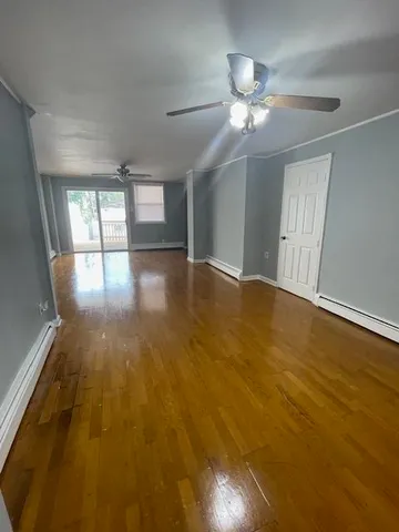 wooden floor in an empty room with a window