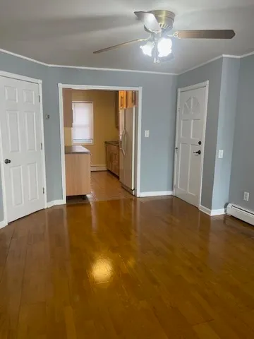 wooden floor in an empty room with a window