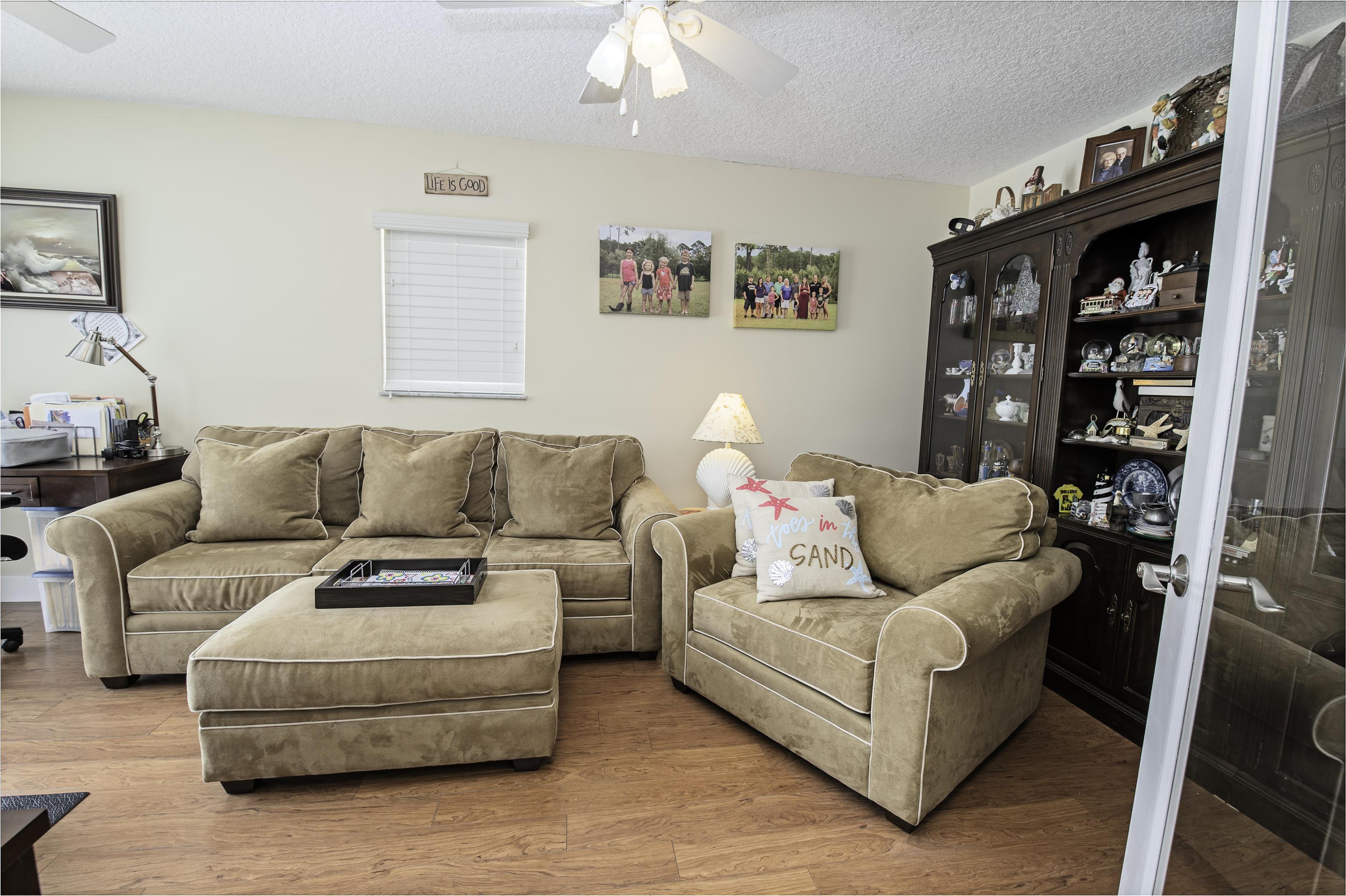 253 Treasure Beach Road St. Augustine, FL 32080 - Photo 21 of 52 a living room with furniture and a couch