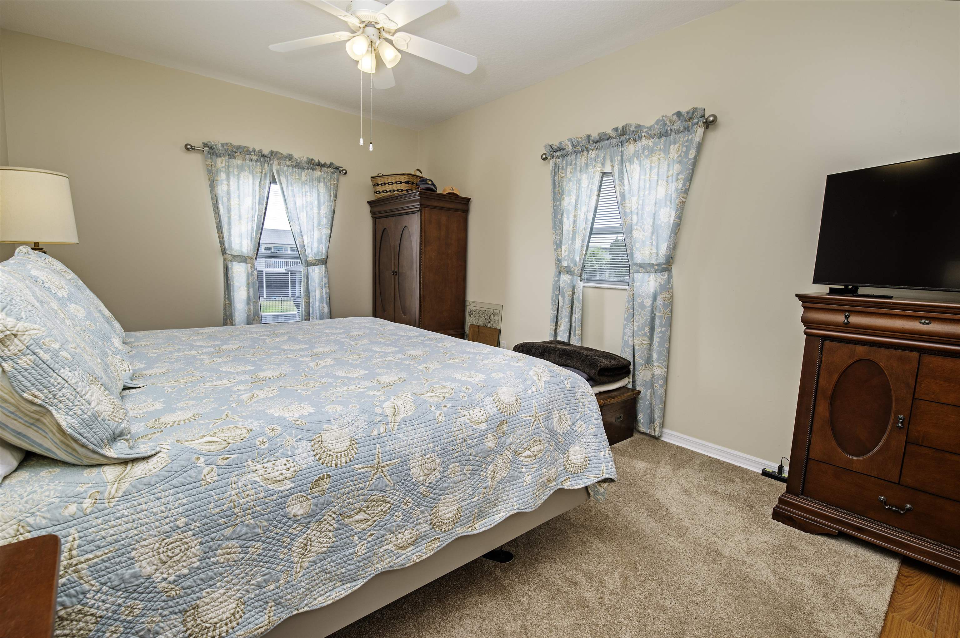 253 Treasure Beach Road St. Augustine, FL 32080 - Photo 25 of 52 a bedroom with a bed dresser and a window