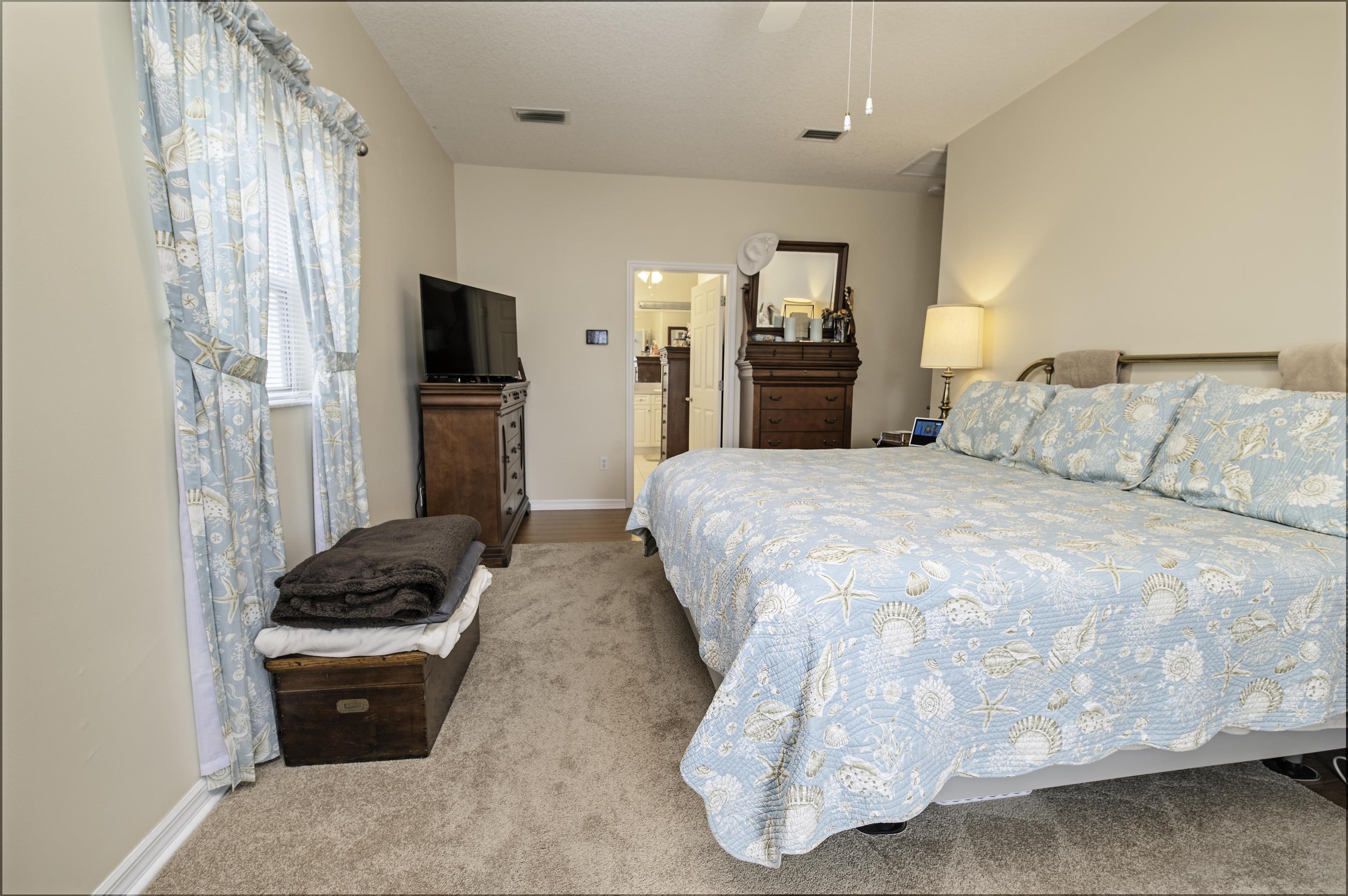 253 Treasure Beach Road St. Augustine, FL 32080 - Photo 26 of 52 a bedroom with a bed and a television