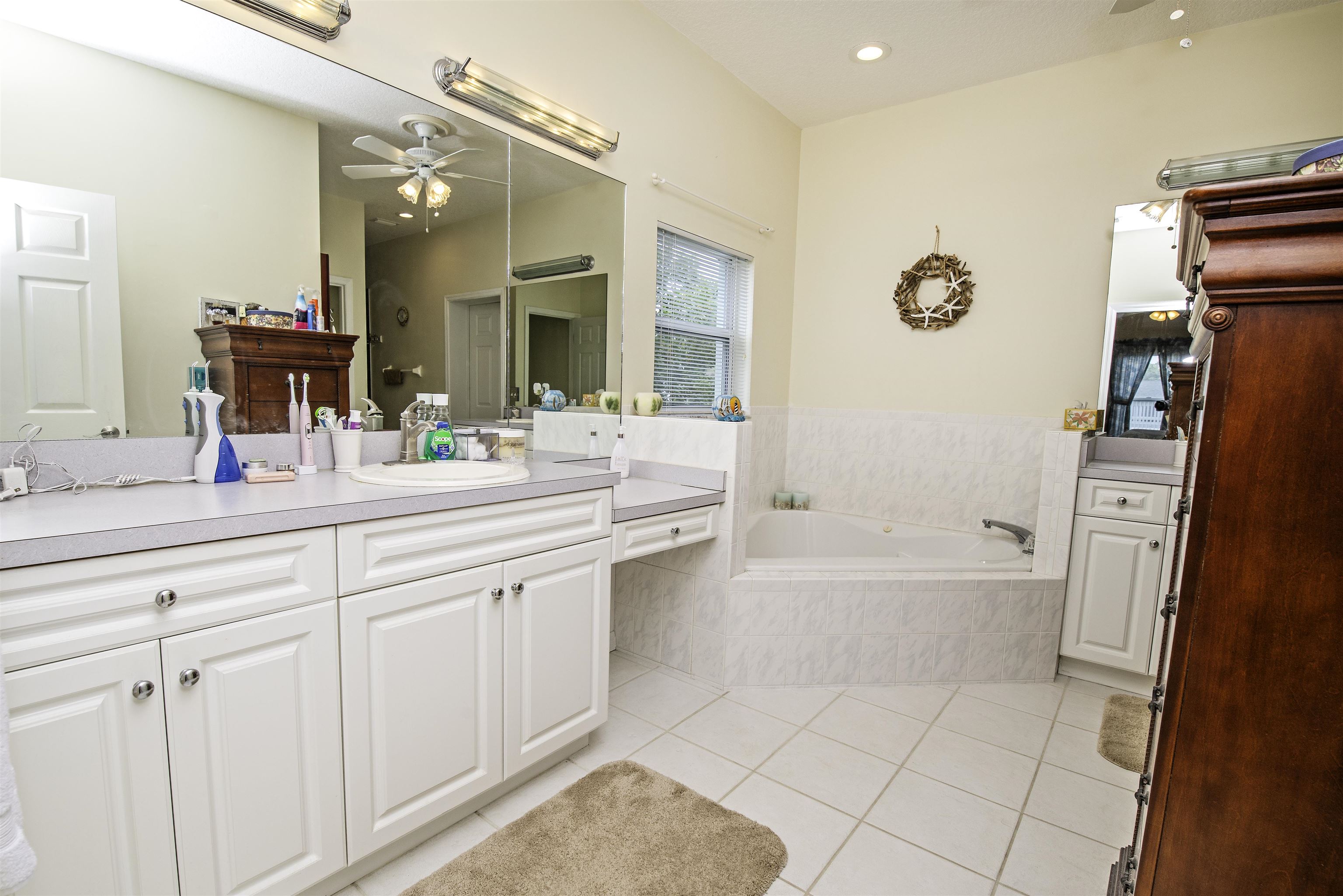 253 Treasure Beach Road St. Augustine, FL 32080 - Photo 27 of 52 a bathroom with a tub sink and mirror