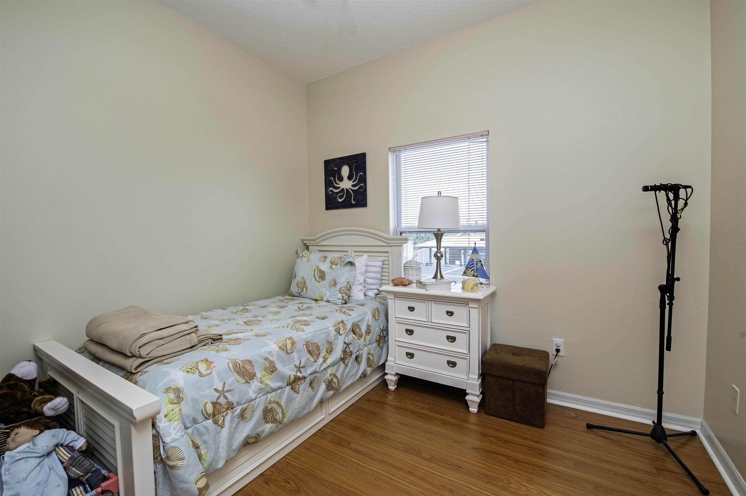 253 Treasure Beach Road St. Augustine, FL 32080 - Photo 31 of 52 a bedroom with a bed and a dresser