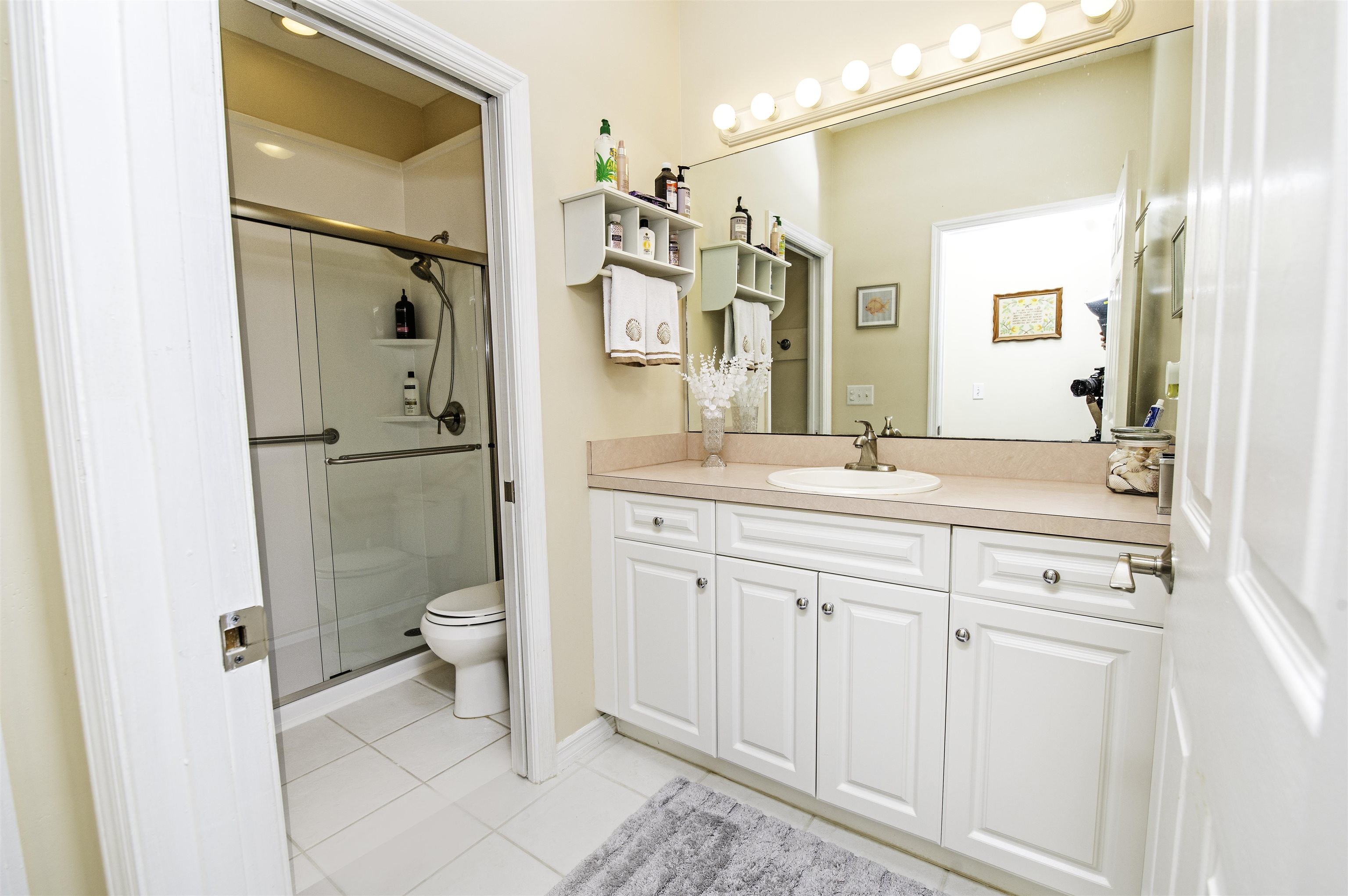 253 Treasure Beach Road St. Augustine, FL 32080 - Photo 37 of 52 a bathroom with a sink a toilet and shower