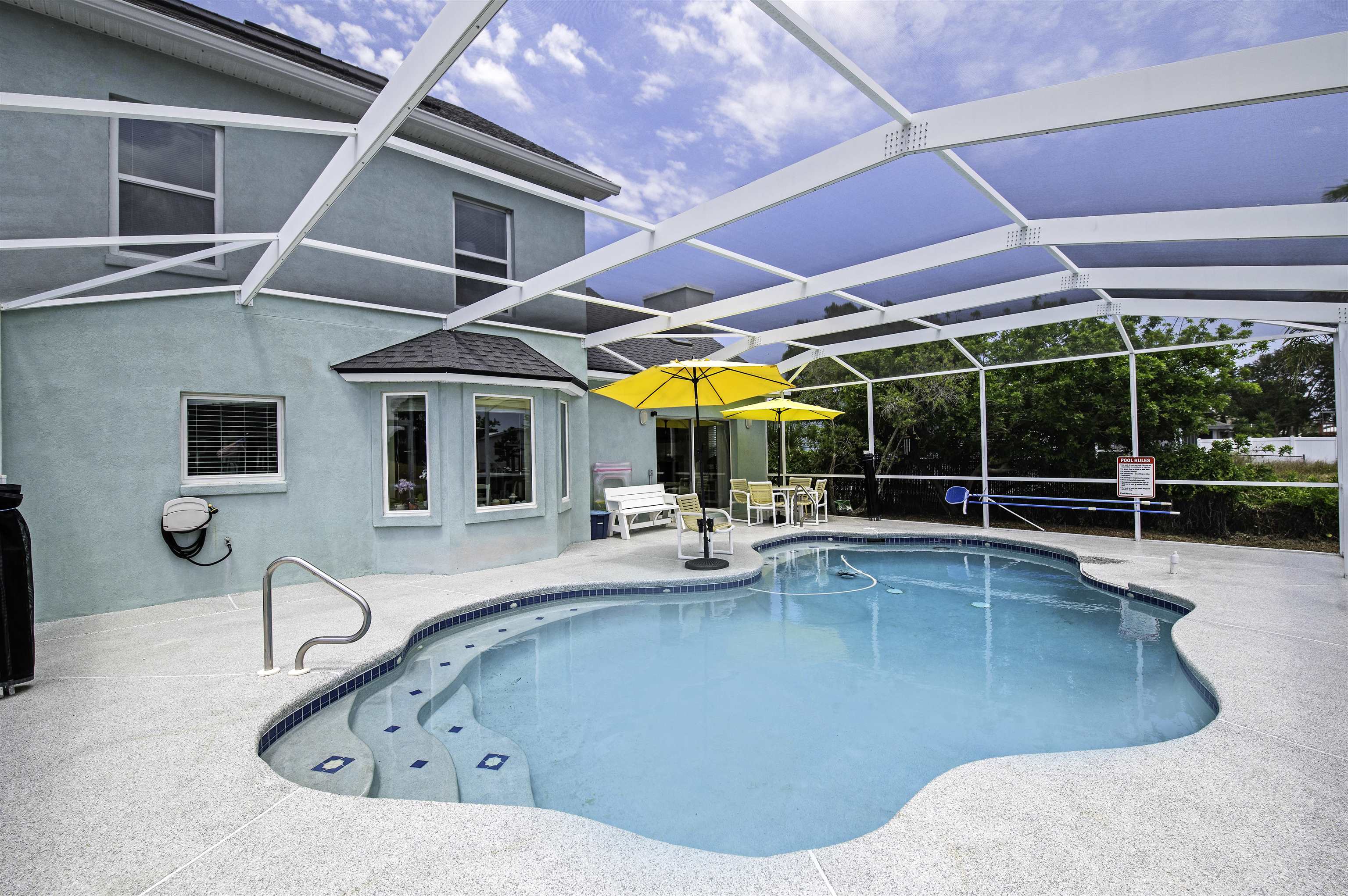 253 Treasure Beach Road St. Augustine, FL 32080 - Photo 40 of 52 a view of a swimming pool with chairs