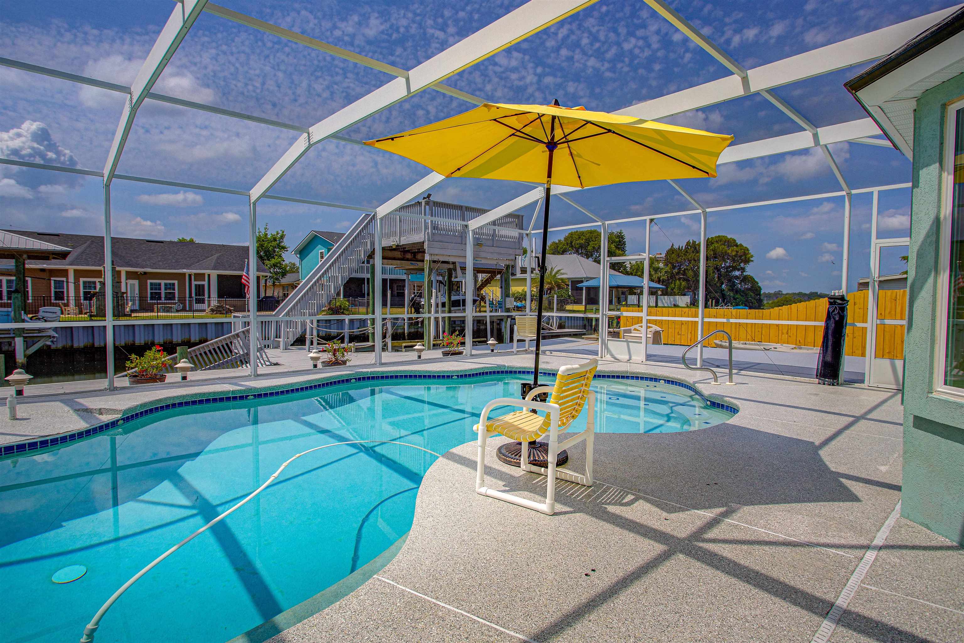 253 Treasure Beach Road St. Augustine, FL 32080 - Photo 4 of 52 a view of a swimming pool with a patio