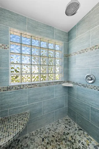 a view of an empty room with wooden floor and windows