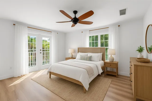 an empty room with a window and a ceiling fan